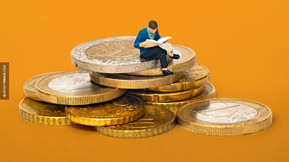 What is your net worth: A man sitting on a pile of coins.